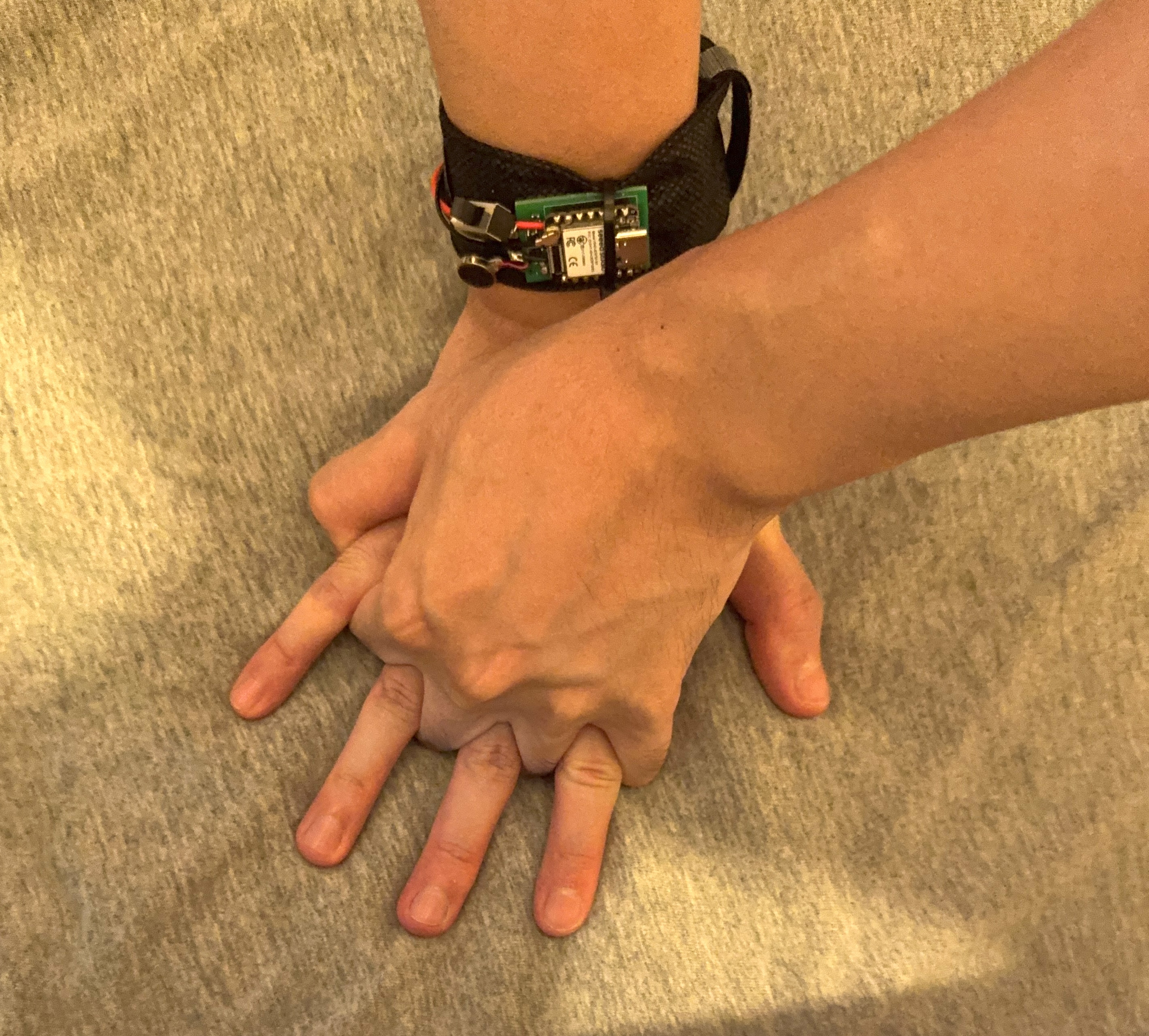 Hands in CPR compression position with the BVM-Assist feedback module worn on the wrist