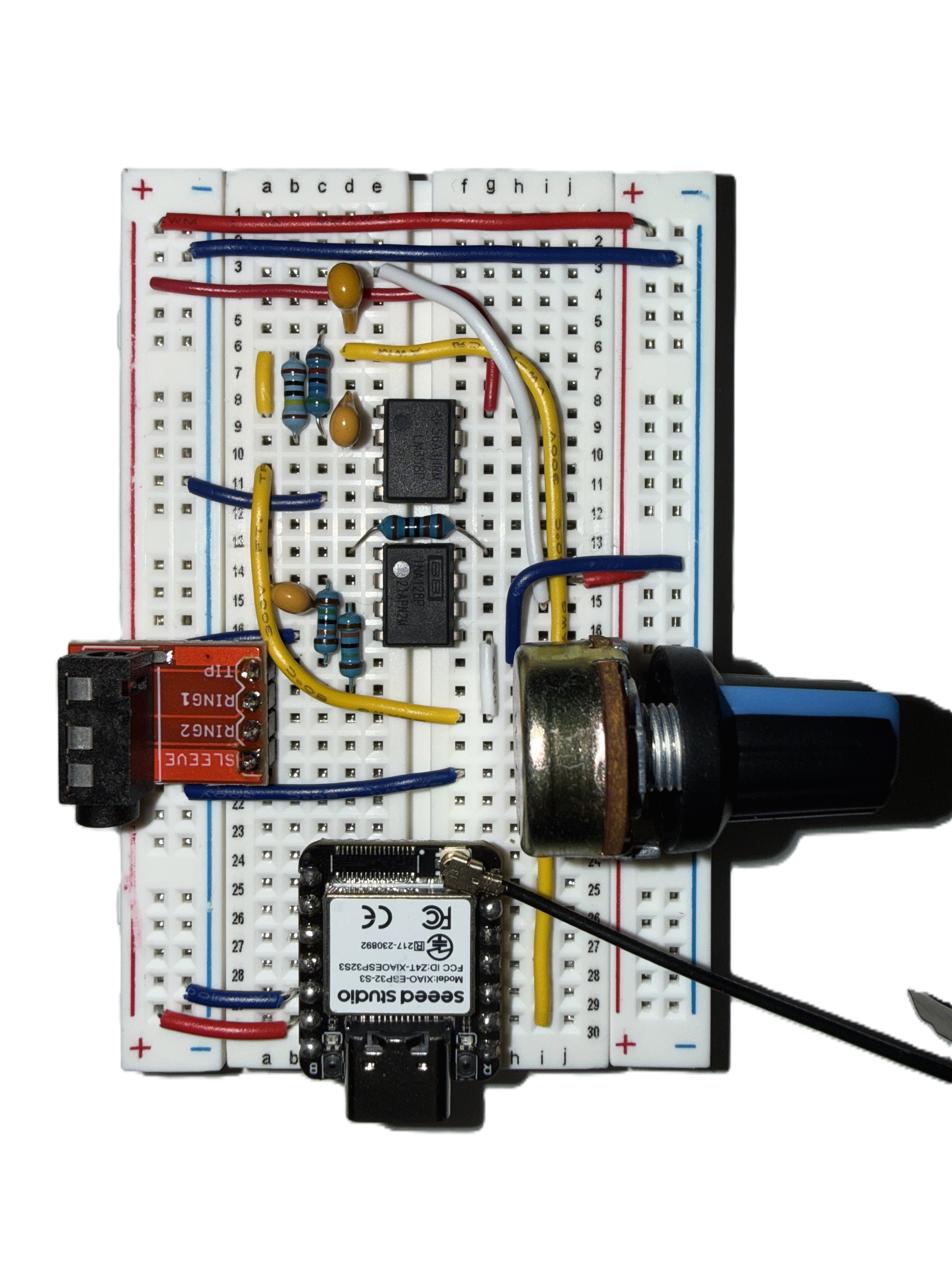 Top view of the ECG breadboard prototype with amplifier circuitry, electrodes, a control knob, and a Seeed Studio microcontroller